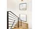 Modern stairwell features wood stairs, black iron railing, and ample natural light at 4398 N Pecos St, Denver, CO 80211