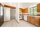 Bright kitchen features tile flooring, white appliances, and ample cabinet space at 4717 Tantra Dr # G5, Boulder, CO 80305