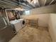 Unfinished basement with washer, dryer, and workspace perfect for storage and utilities at 7810 Pontiac St, Commerce City, CO 80022