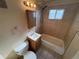 Tiled bathroom with vanity, mirror, and tub/shower combo in this house needing some renovation at 7810 Pontiac St, Commerce City, CO 80022