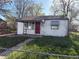 Charming single-story home featuring red door, white siding, and a cozy front yard at 7810 Pontiac St, Commerce City, CO 80022