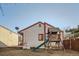 Backyard view showcasing a play structure, partial fencing, and an exterior of the home at 17949 E Ohio Cir, Aurora, CO 80017