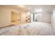 Spacious basement with neutral carpet, built-in shelving, and room for recreation at 17949 E Ohio Cir, Aurora, CO 80017