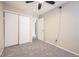 A cozy bedroom with a ceiling fan, closet, and neutral décor at 17949 E Ohio Cir, Aurora, CO 80017