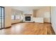 Bright living room featuring hardwood floors, a cozy fireplace, and large windows at 17949 E Ohio Cir, Aurora, CO 80017