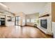 Open-concept living room featuring wood floors, brick fireplace and access to the kitchen at 17949 E Ohio Cir, Aurora, CO 80017