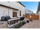 Cozy backyard with patio furniture, grill, string lights, and low maintenance landscaping at 10149 Xanadu Street, Commerce City, CO 80022