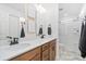 Modern bathroom with double vanity, framed mirrors, and glass-enclosed shower at 10149 Xanadu Street, Commerce City, CO 80022