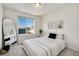 Bright bedroom featuring a large window, stylish décor, and comfortable striped bedding at 10149 Xanadu Street, Commerce City, CO 80022