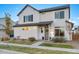 Beautiful two-story home with a well-maintained lawn, front yard, and gray front door at 10149 Xanadu Street, Commerce City, CO 80022