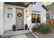 Charming front door with a wreath, decorative plants, and a welcoming doormat at 10149 Xanadu Street, Commerce City, CO 80022