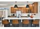 Open kitchen features a large island with seating, stainless appliances, and stylish pendant lighting at 10149 Xanadu Street, Commerce City, CO 80022