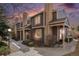 Attractive two-story townhome with brick accents, covered porches, and mature landscaping at sunset at 804 Summer Dr, Highlands Ranch, CO 80126