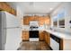 Efficient kitchen with bright white cabinets, modern appliances, and durable stone tile flooring at 804 Summer Dr, Highlands Ranch, CO 80126