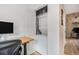 Convenient in-unit laundry area featuring a stacked washer and dryer setup near a desk space at 804 Summer Dr, Highlands Ranch, CO 80126