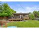 Backyard offers large deck with pergola, lawn, and privacy fence at 2703 N Milwaukee St, Denver, CO 80205