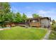 Backyard offers large deck with pergola, lawn, and privacy fence at 2703 N Milwaukee St, Denver, CO 80205