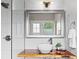 A bright bathroom featuring a glass walk-in shower, wood slab sink counter, and bowl sink at 2703 N Milwaukee St, Denver, CO 80205