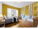 Bedroom with hardwood floors, a large window, and hand-painted tree mural at 2703 N Milwaukee St, Denver, CO 80205