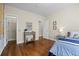 Bedroom featuring hardwood floors, closet, and a hall entry way at 2703 N Milwaukee St, Denver, CO 80205