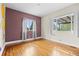 Vacant bedroom with wood floors, natural light, and painted accent wall at 2703 N Milwaukee St, Denver, CO 80205