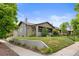 Charming bungalow with a well-kept lawn and landscaping, showcased from a corner street view at 2703 N Milwaukee St, Denver, CO 80205