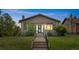 Charming craftsman-style bungalow with a welcoming front porch and well-maintained lawn at dusk at 2703 N Milwaukee St, Denver, CO 80205