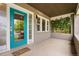 Welcoming front porch with a vibrant blue door, green climbing plants, and the house number at 2703 N Milwaukee St, Denver, CO 80205