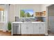 Kitchen sink with view to backyard, white cabinetry and stainless steel appliances at 2703 N Milwaukee St, Denver, CO 80205