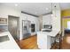 Updated kitchen with white cabinetry, stainless steel appliances, and a breakfast bar at 2703 N Milwaukee St, Denver, CO 80205
