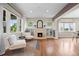 Cozy living room with hardwood floors, a decorative fireplace, and built-in shelving at 2703 N Milwaukee St, Denver, CO 80205