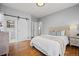 Bright main bedroom featuring a barn door leading to the bathroom and beautiful hardwood floors at 2703 N Milwaukee St, Denver, CO 80205