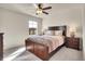 Bright bedroom with ceiling fan and wood furniture at 16686 Rinker Way, Broomfield, CO 80023