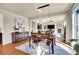Open dining area with hardwood floors and a view of the living room at 16686 Rinker Way, Broomfield, CO 80023
