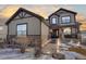 Two-story house with lights illuminating the walkway at dusk at 16686 Rinker Way, Broomfield, CO 80023