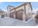 Three-car garage with stone accents at 16686 Rinker Way, Broomfield, CO 80023