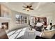 Open living room with fireplace, kitchen view, and lots of natural light at 16686 Rinker Way, Broomfield, CO 80023