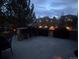 Outdoor kitchen featuring stone bar, seating, lights, and built-in grill on patio at 16686 Rinker Way, Broomfield, CO 80023