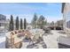 Stone patio with fire pit and seating at 16686 Rinker Way, Broomfield, CO 80023
