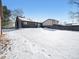 Large backyard with snow cover and detached garage at 245 Cedar St, Hudson, CO 80642