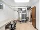 Unfinished basement with water heater and work area at 245 Cedar St, Hudson, CO 80642