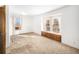 Bright bedroom with built-in window seat and abundant natural light at 245 Cedar St, Hudson, CO 80642