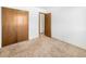 Simple bedroom with double doors and carpeting at 245 Cedar St, Hudson, CO 80642
