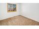 Bright bedroom with large window and neutral carpeting at 245 Cedar St, Hudson, CO 80642