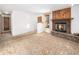 Open living room with access to hallway and fireplace at 245 Cedar St, Hudson, CO 80642