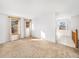 Spacious living room featuring large windows and neutral carpeting at 245 Cedar St, Hudson, CO 80642