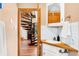 Bathroom sink with subway tile and wooden countertop next to a view of the spiral staircase at 200 The Lane Rd, Golden, CO 80403