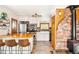 Bright kitchen with white cabinets, butcher block counters, stainless steel appliances, and a charming brick accent wall at 200 The Lane Rd, Golden, CO 80403