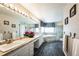 Luxurious bathroom with dual sinks, large vanity, modern fixtures, soaking tub, and decorative accents at 15407 E Crestline Pl, Centennial, CO 80015