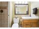 Cozy bathroom featuring a tiled shower, classic vanity, and neutral color palette at 15407 E Crestline Pl, Centennial, CO 80015